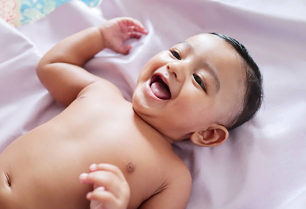 A-cute-Indian-innocent-new-born-baby-in-a-jovial-mood-with-a-charming-smile